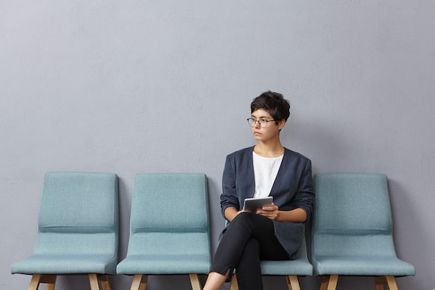 Young woman sitting in waiting room