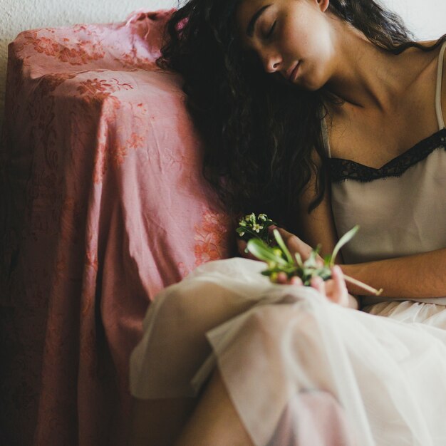 Young woman sleeping with flowers