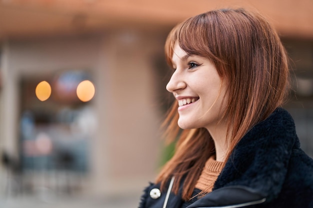 Young woman smiling confident standing at street