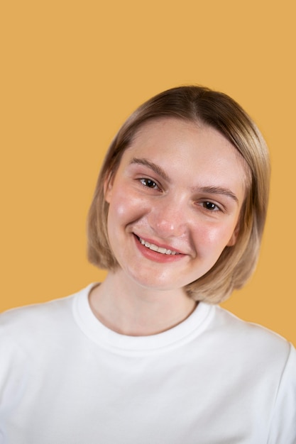 Young woman smiling isolated on yellow