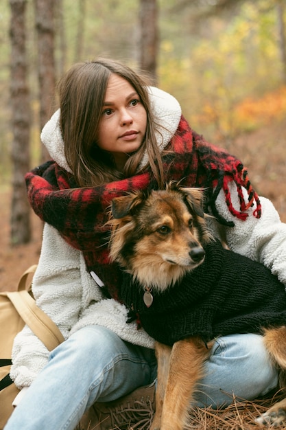 Young woman spending time together with her dog outdoors