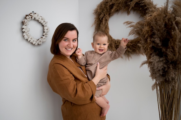 Free photo young woman spending time with her baby