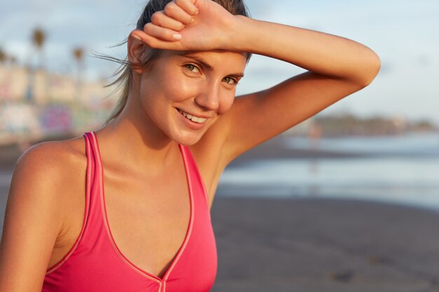 Young woman in sportswear on the beach