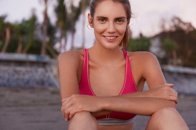 Young woman in sportswear on the beach