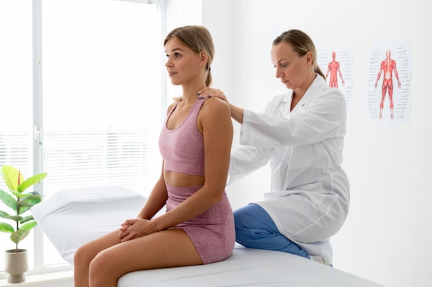 Young woman in sportswear practicing an exercise in a physiotherapy session