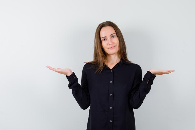 Young woman spreading palms aside