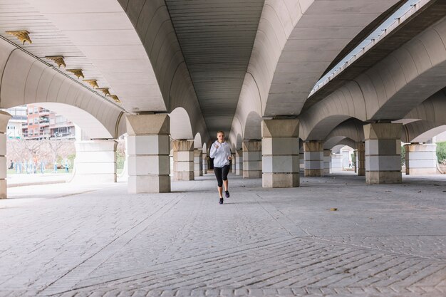 Young woman sprinting on street