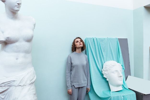 Young woman standing against a wall