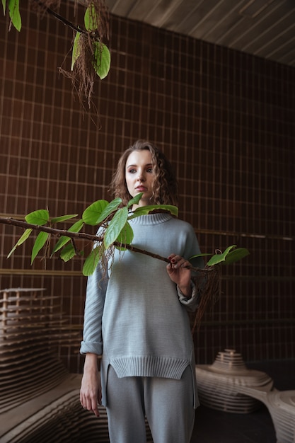 Free photo young woman standing on an art platform