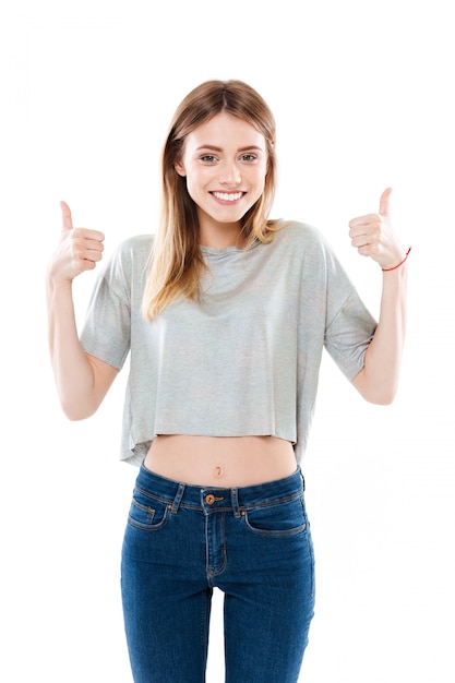 Young woman standing and giving thumbs up with two hands