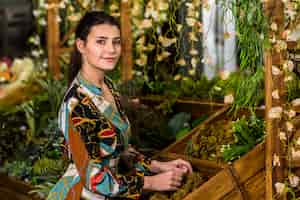 Free photo young woman standing in green house