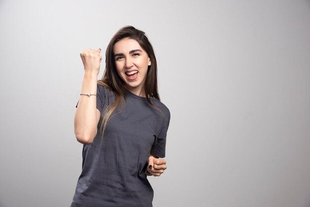 Young woman standing and posing with fist up