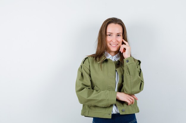 Young woman standing in thinking pose in shirt and looking alluring. front view.