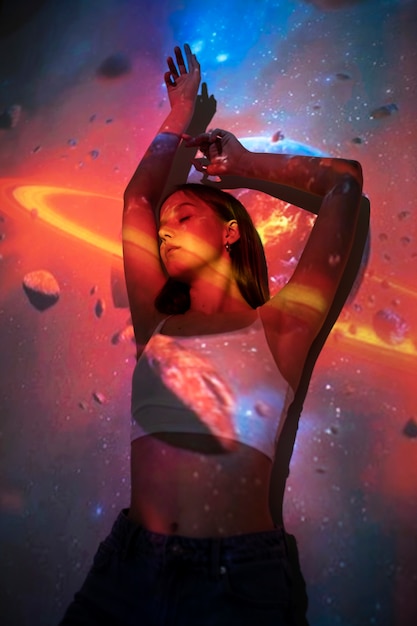 Young woman standing in universe texture projection