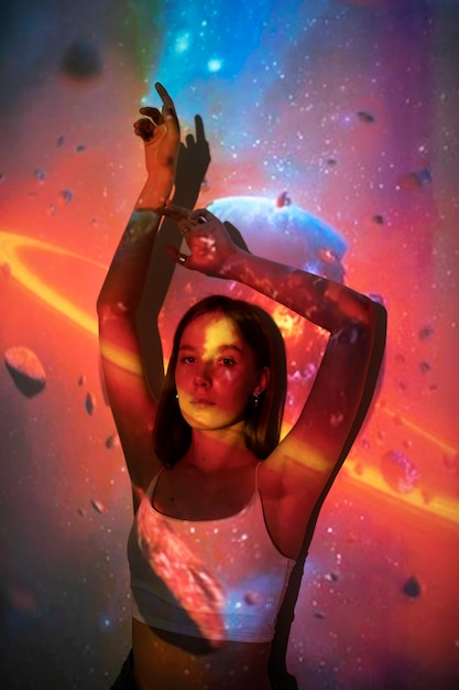 Young woman standing in universe texture projection