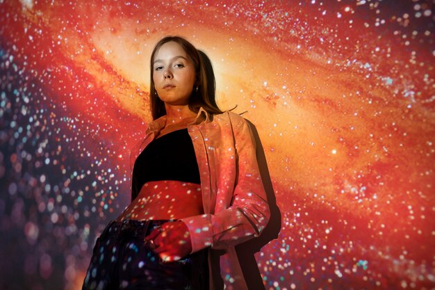 Young woman standing in universe texture projection