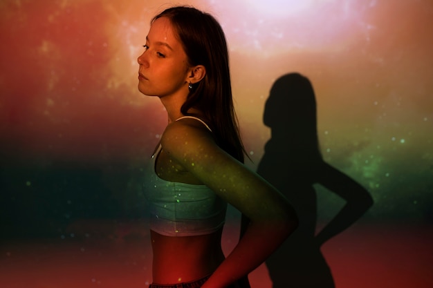 Free photo young woman standing in universe texture projection