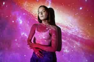 Free photo young woman standing in universe texture projection