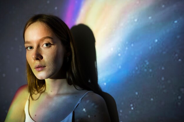 Young woman standing in universe texture projection