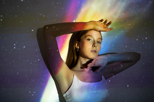 Free photo young woman standing in universe texture projection