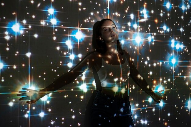 young woman standing in universe texture projection