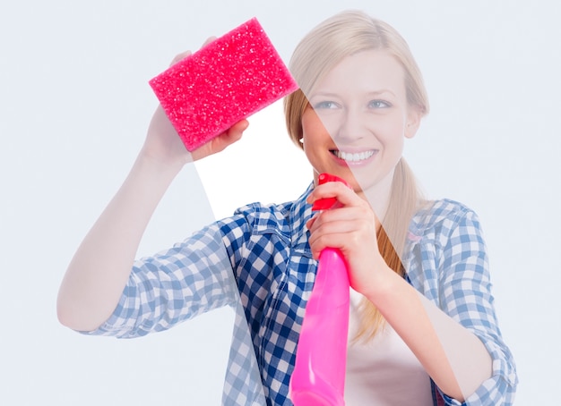 Free photo young woman standing behind window and washing it