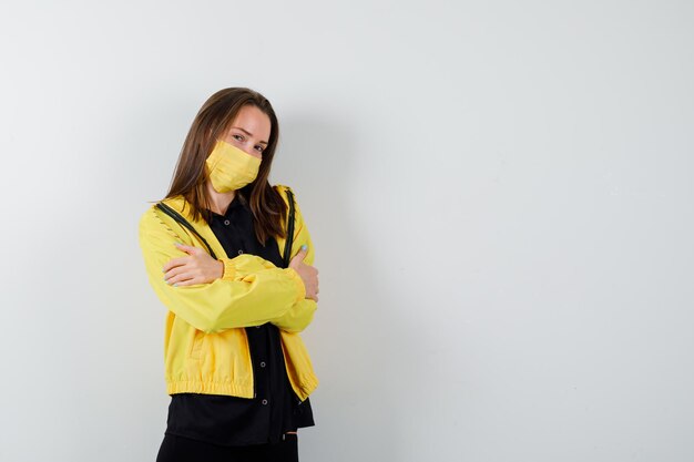 Young woman standing with arms crossed