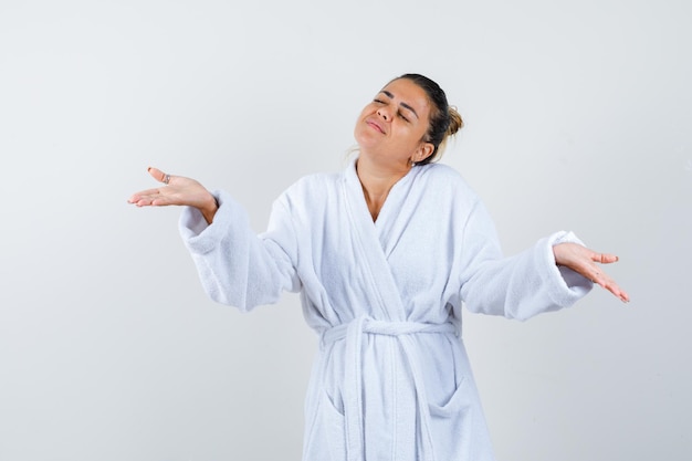 Free photo young woman stretching hands in questioning manner