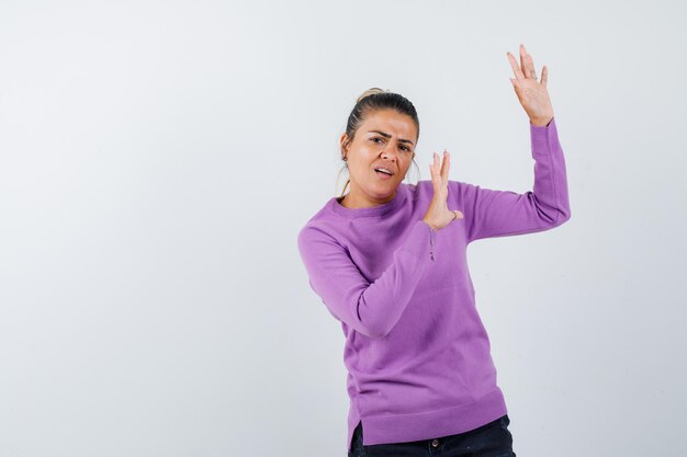 Young woman stretching hands to stop