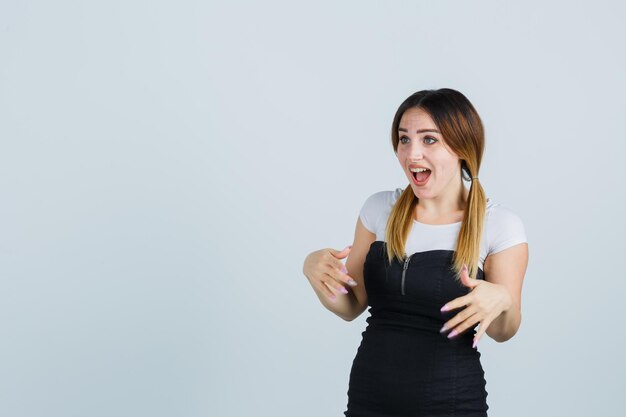 Young woman stretching hands in surprised manner