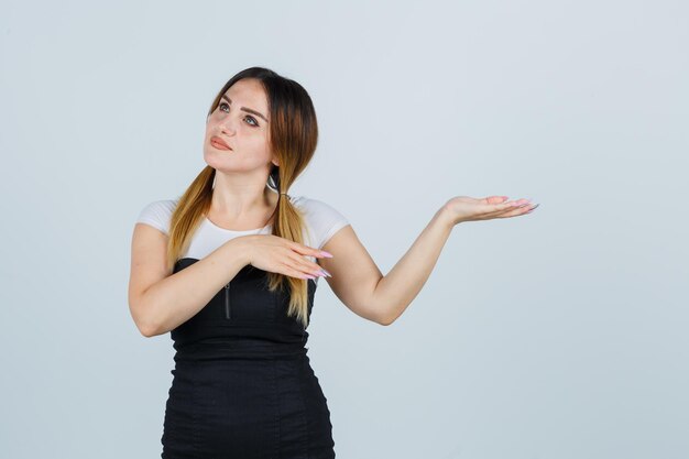 Young woman stretching hands towards right