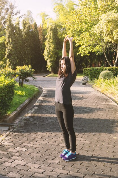 Young woman stretching her arms outdoors
