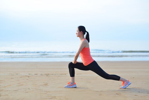 Young woman stretching her legs