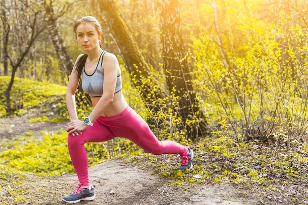 Young woman stretching in the nature