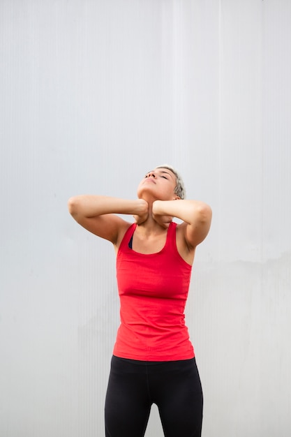 Free photo young woman stretching outside