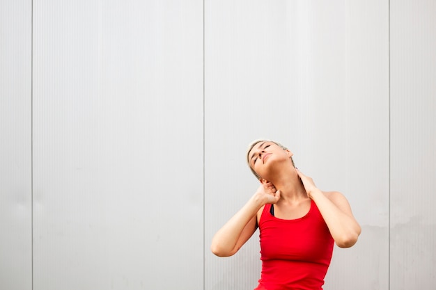 Free photo young woman stretching outside