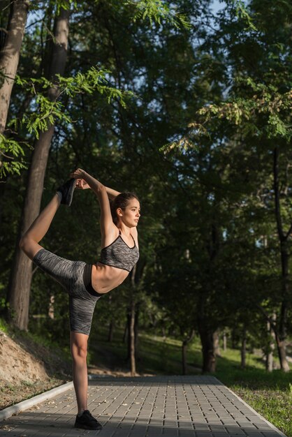 Young woman stretching in the park