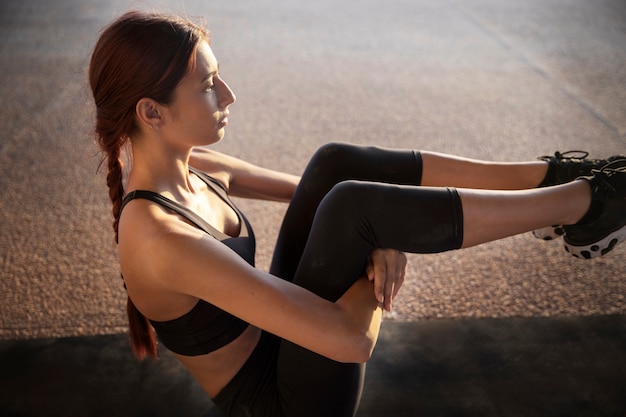 Young woman stretching and preparing for exercise outdoors