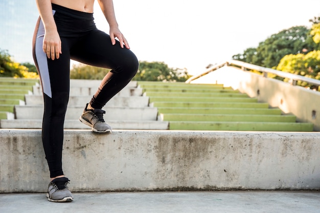 Young woman stretching at the street