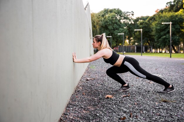 Young woman stretching at the street