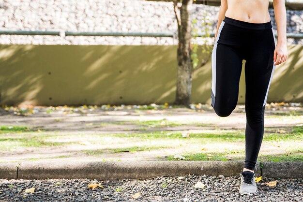 Young woman stretching at the street