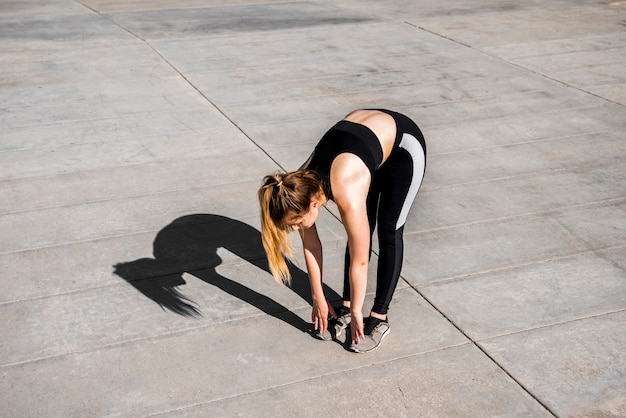 Young woman stretching at the street