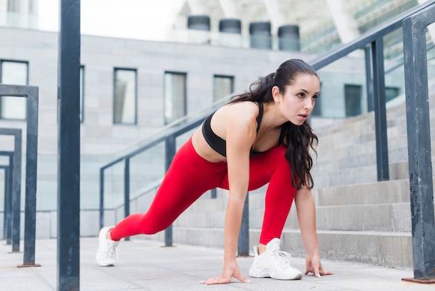 Young woman stretching in the street