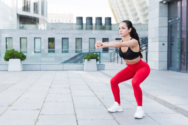 Young woman stretching in the street