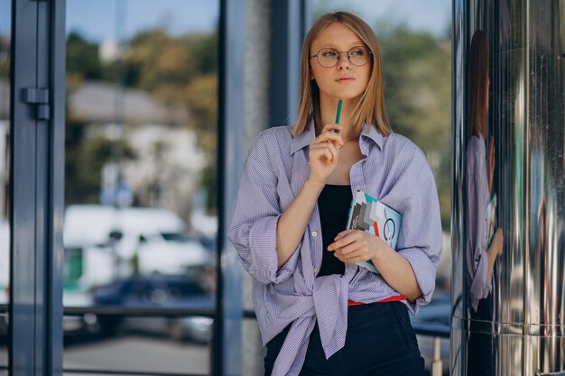 ノートブックを持つ若い女性学生