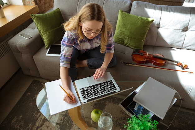 Young woman studying at home during online courses