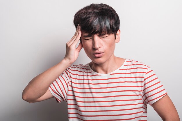 Young woman suffering from headache isolated over white background