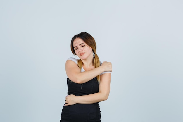 Free photo young woman suffering from shoulder pain