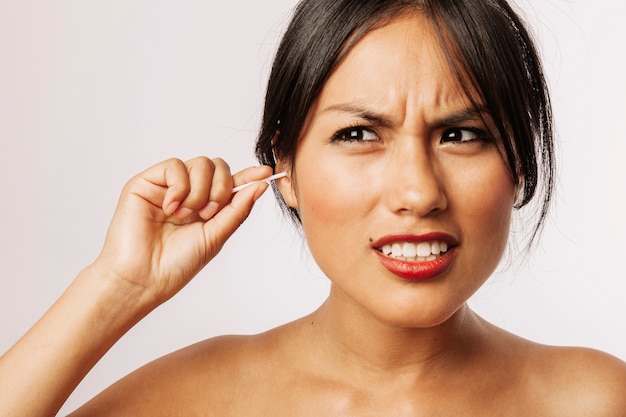 Young woman suffering with the cotton swabs