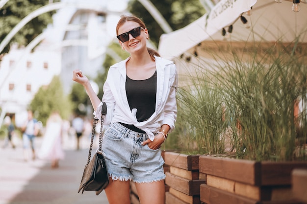 Young woman in summer outfit in town